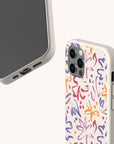 Two smartphones in beige cases are shown: one with the screen visible, and the other featuring the Flower Strokes Eco-Friendly Phone Case, which displays an abstract floral and butterfly pattern in red, purple, orange, and blue on a light background.