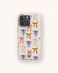 The Bows Eco-Friendly Biodegradable Phone Case features a light beige background adorned with a pattern of hand-drawn bows in pink, purple, and orange.