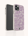 The Purple Marble Swirl Eco-Friendly Phone Case, showcasing a beige and purple wavy marble pattern with precise cutouts for the camera and buttons, stands upright on a light background.