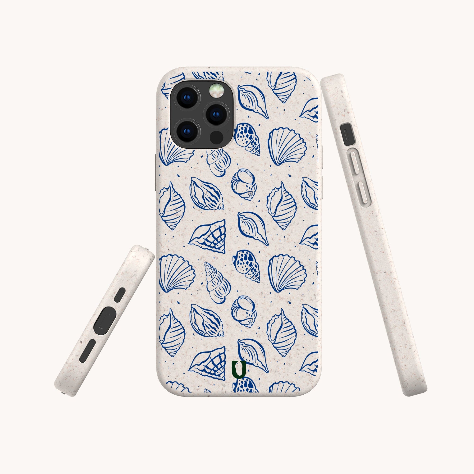 Three white Sea Shells Eco-Friendly Phone Cases display a blue seashell and leaf pattern, with one showing the back and two highlighting side views, including button and port openings. Compatible with iPhone and Samsung Galaxy.