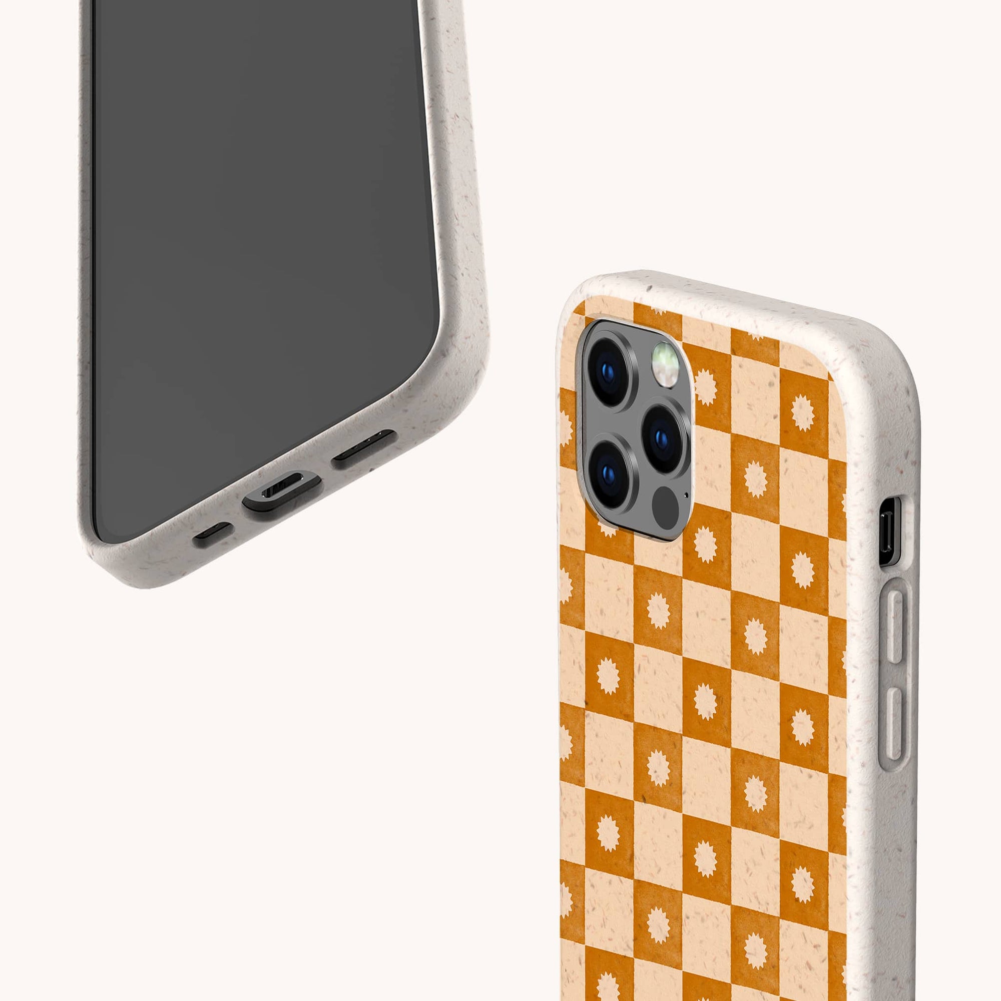 Two smartphones with beige speckled, eco-friendly phone cases; one displays the screen, while the other shows the Star Terracotta Checker Eco-Friendly Phone Case’s retro orange and cream checkerboard pattern with white flowers on the back.