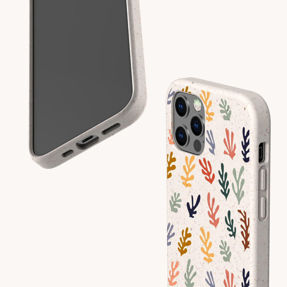 Two Algae Eco-Friendly Phone Cases in beige are shown—one with a vibrant coral pattern and the other plain. These biodegradable cases clearly display their ports and buttons, set against a clean, pale background.