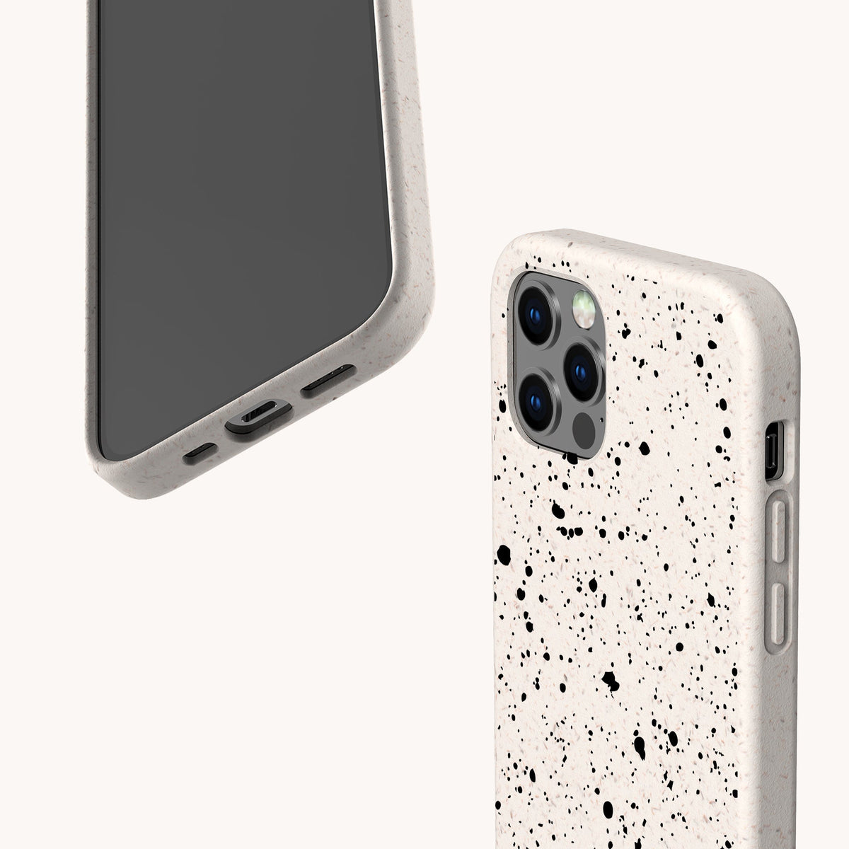 Two smartphones with Black Splatter Eco-Friendly Phone Cases are shown on a light background. Each white case features a bold black paint splatter design; one phone displays its screen, while the other highlights the camera and side buttons.