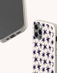Two beige phone cases are shown. One, the Wonky Stars Biodegradable Phone Case, features a dark star pattern on the back, while the other displays its front and bottom sides, highlighting cutouts for the charging port, speakers, and side buttons.