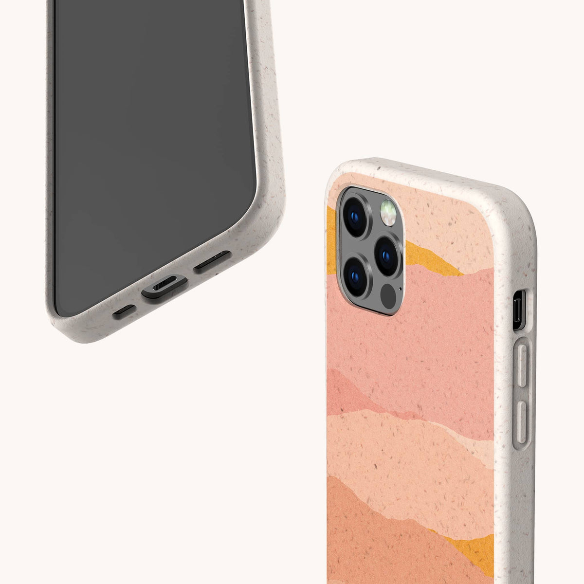 Two smartphones in speckled beige Mountains Eco-Friendly Phone Cases; one displays the screen and bottom ports, while the other shows the camera and a pink, peach, and orange abstract wave design on the back. These eco-friendly Mountains cases are compatible with iPhone and Samsung devices. Background is off-white.