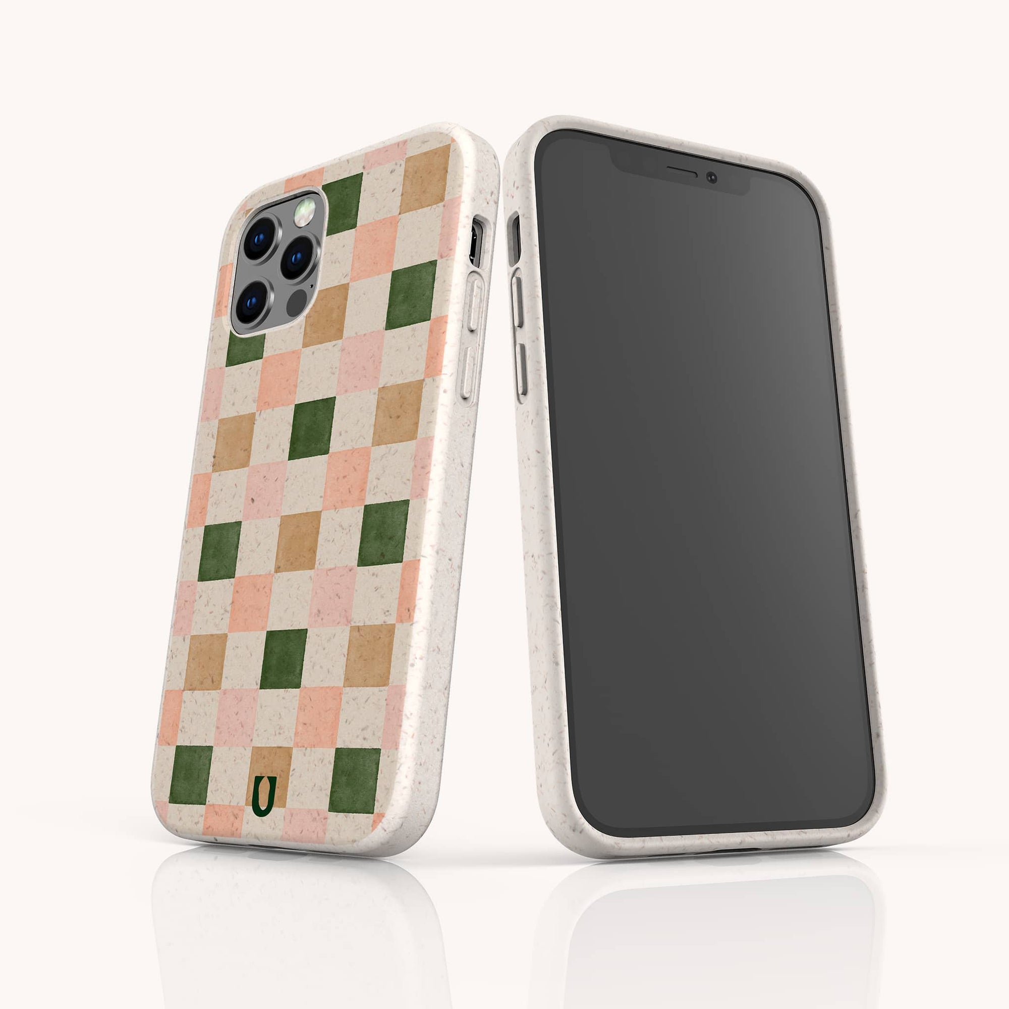 The Pink and Green Checker Eco-Friendly Phone Case features a beige, vegan-friendly design with muted pink, tan, and green checks plus a small horseshoe logo. Compatible with iPhone and Samsung Galaxy devices.