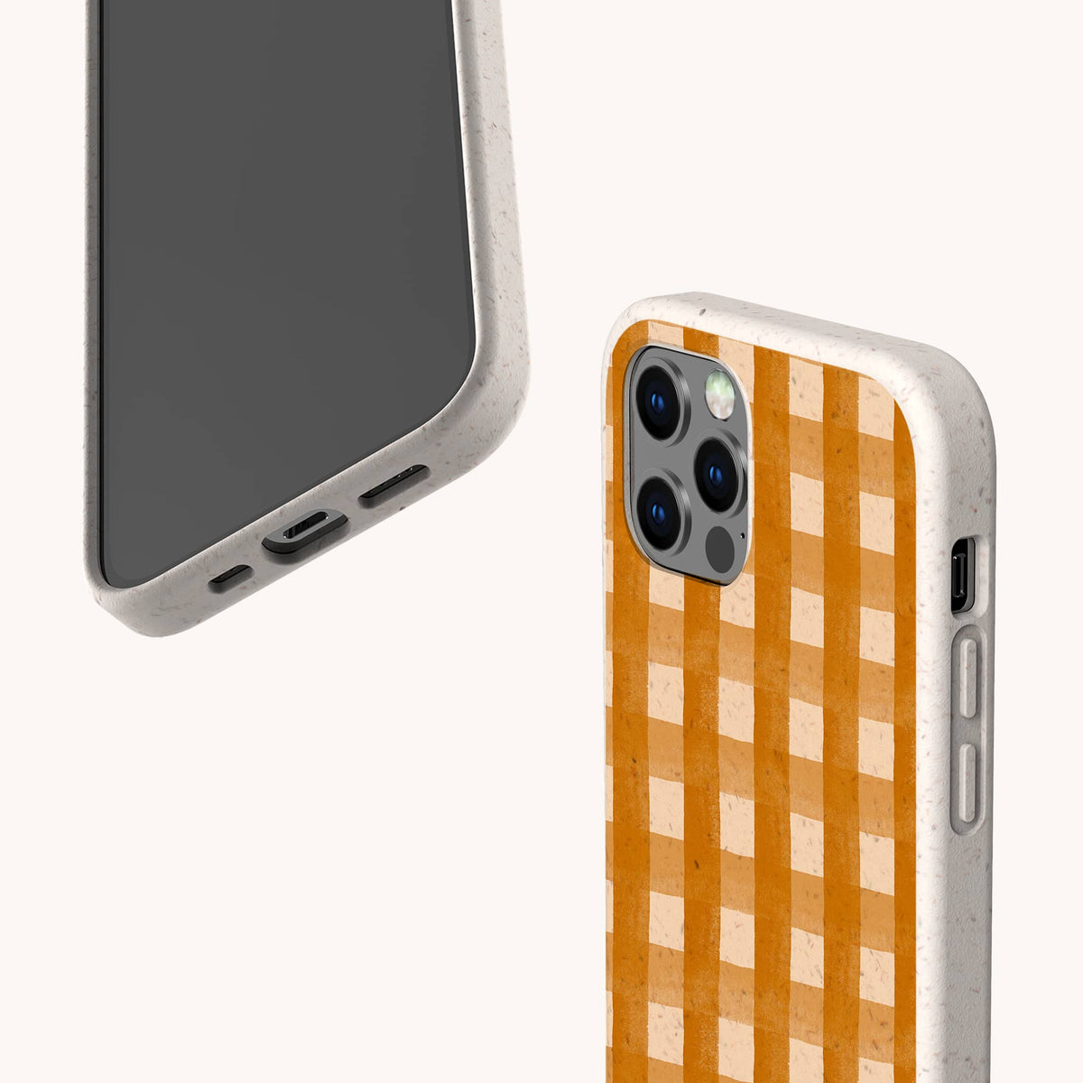 Two smartphones featuring the Terracotta Watercolour Gingham Eco-Friendly Phone Case in beige are displayed; one showcases a solid orange and white terracotta gingham pattern, while the other highlights the case’s precise port and button cutouts. Both phones rest against a simple, light background, emphasizing their sustainable design.