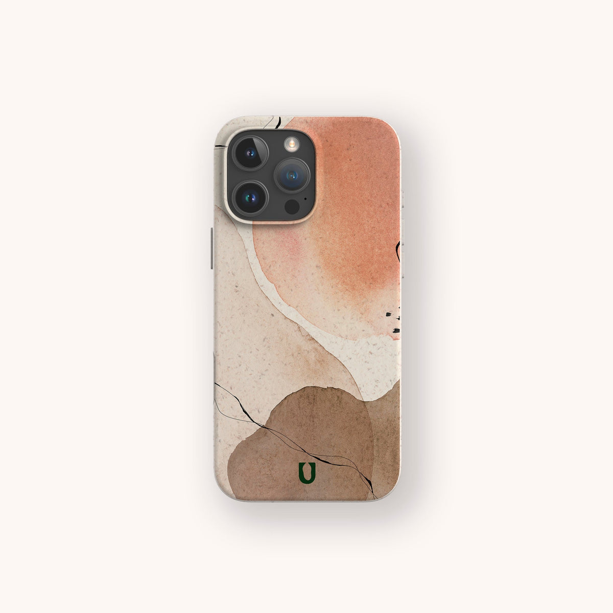 IPhone with the Pink and Brown Watercolour Eco-Friendly Phone Case, featuring abstract watercolor shapes in peach, tan, and beige tones accented by thin black lines and a small green “U” logo at the bottom center. The background is off-white.