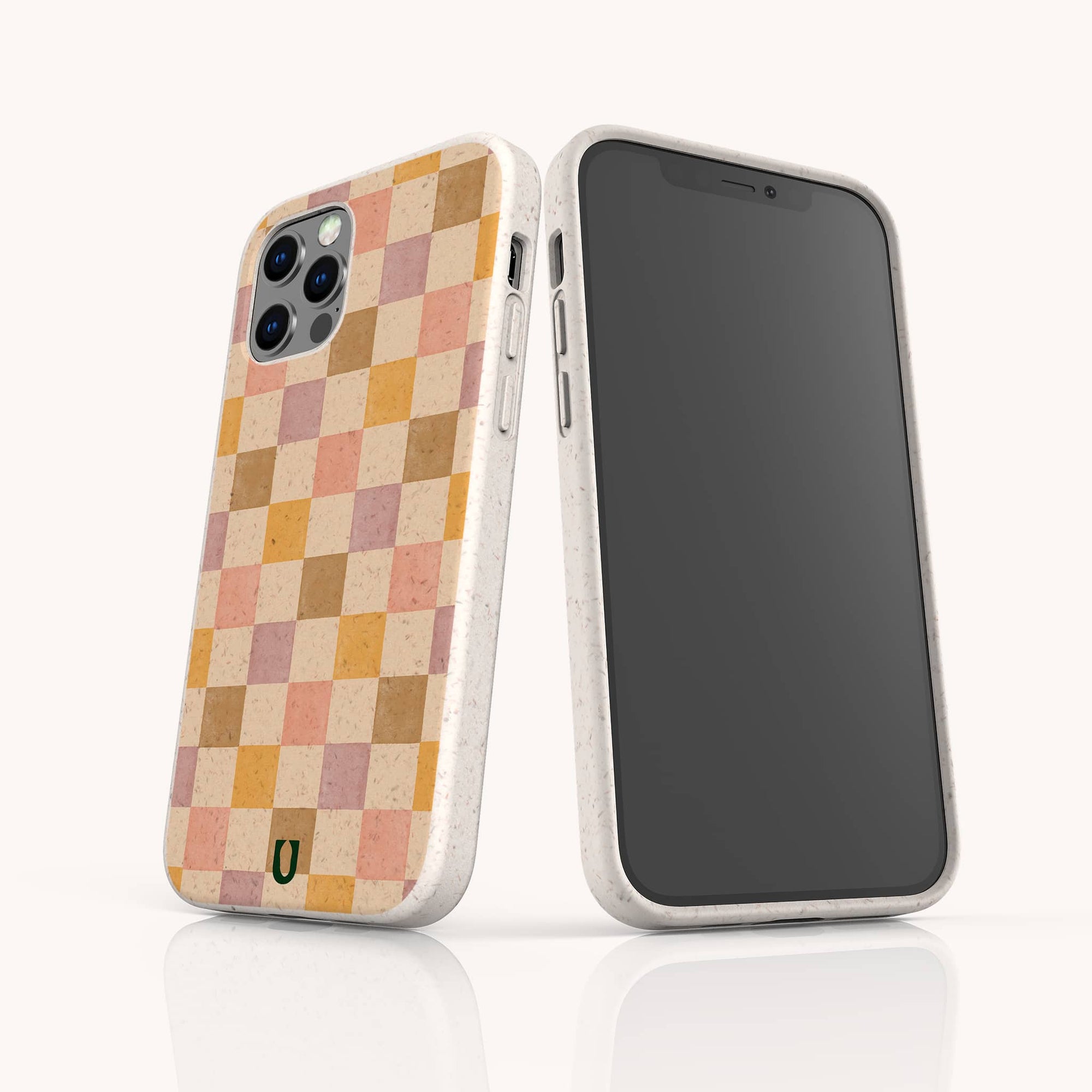 Two smartphones in beige, eco-friendly cases; one features the Pink and Purple Checker Eco-Friendly Phone Case with a green horseshoe logo, and the other has a blank black screen.