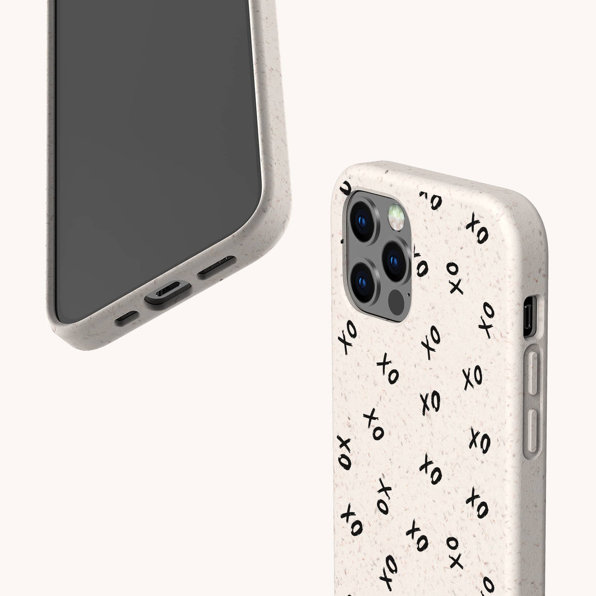 Two smartphones fitted with beige Xo Xo Eco-Friendly Biodegradable Phone Cases; one case is decorated with a black XO pattern. The phones are positioned to highlight the camera, side buttons, and charging port against a plain white background.