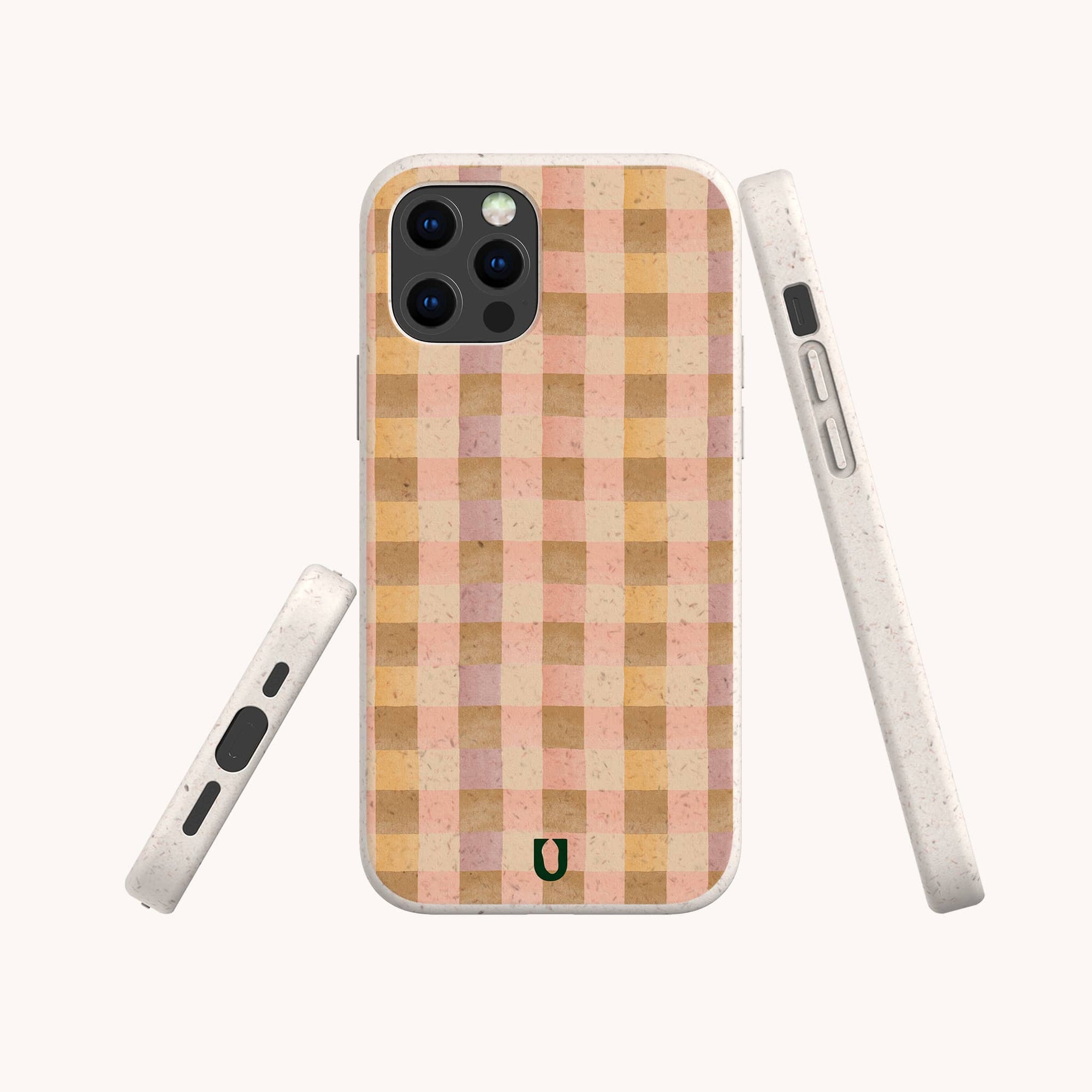 The Pink Watercolour Gingham Eco-Friendly Phone Case features a beige and pink checkered pattern, rounded edges, compostable materials, and a small dark horseshoe symbol near the bottom. Shown from multiple angles on a white background.