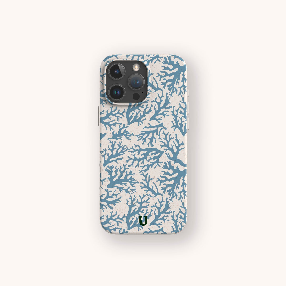 Introducing the Blue Coral Eco-Friendly Phone Case: inspired by the ocean, this elegant smartphone accessory showcases intricately detailed branches of coral in multiple blue hues on a crisp white backdrop. A small green logo at the bottom center highlights its eco-friendly nature, completing the sophisticated design.