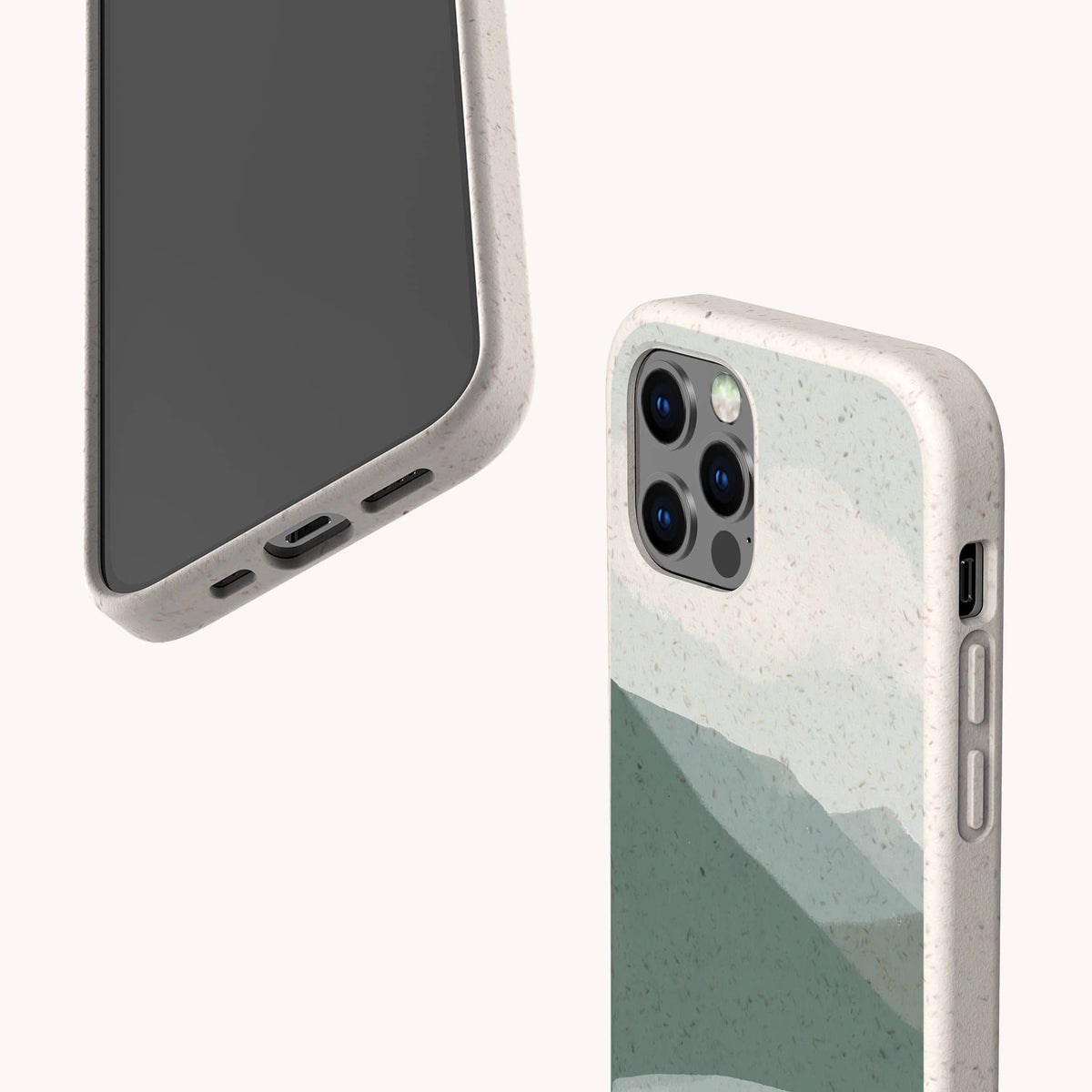 Two smartphones with beige speckled, biodegradable phone cases; one shows the screen and charging port, while the other displays the back, featuring the Blue Watercolour Landscape Eco-Friendly Phone Case design—a green abstract mountain motif and a triple camera setup.