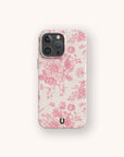 Pink Roses Eco-Friendly Phone Case on an iPhone, featuring vintage-style pink floral patterns and a small black U-shaped logo at the bottom, displayed on a light background.