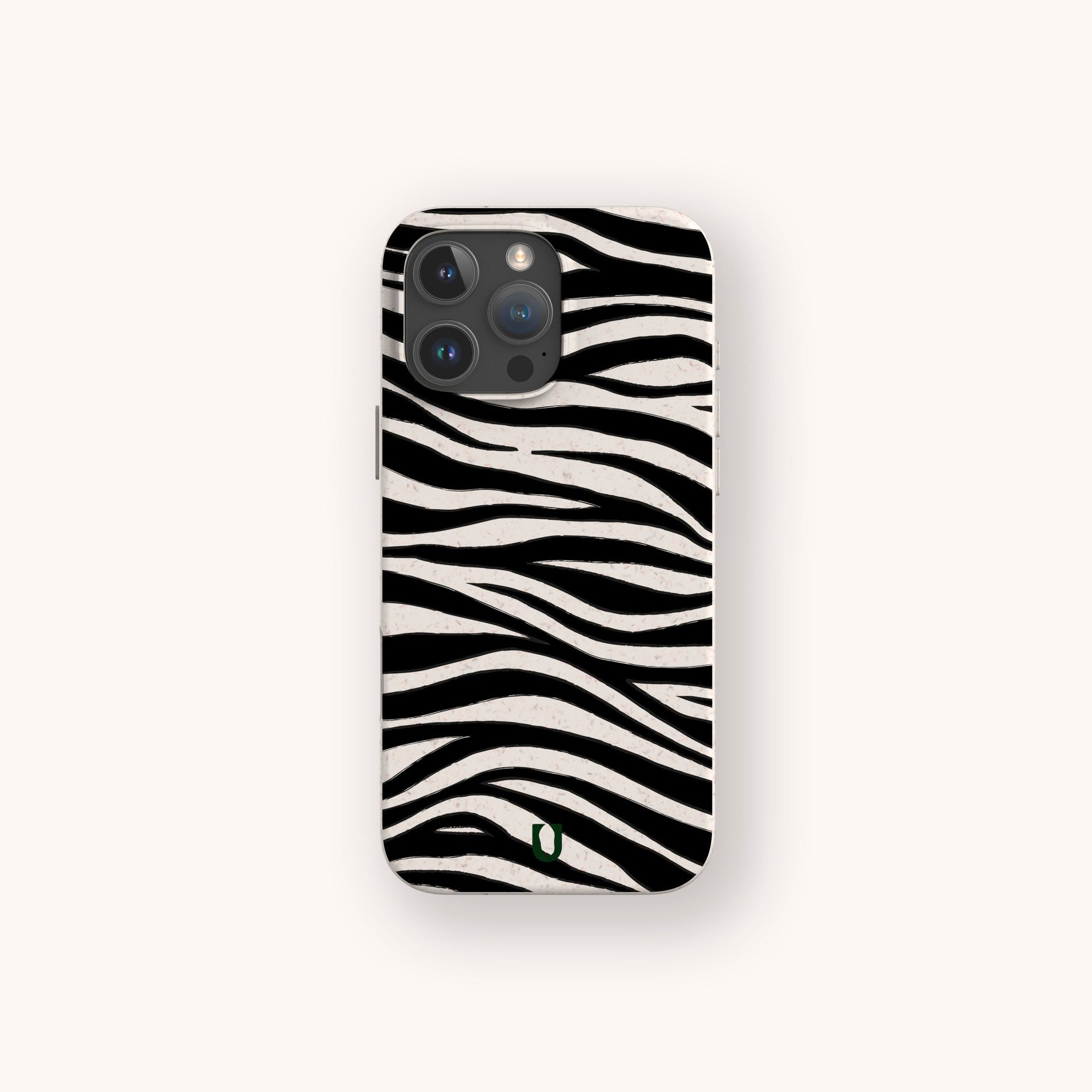The Zebra Eco-Friendly Phone Case, featuring black and white zebra stripes inspired by animal designs, is displayed on a light background. A small green logo at the bottom highlights its compostable, biodegradable materials.