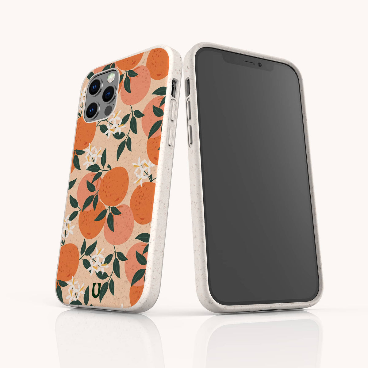 Two smartphones in beige cases stand upright on a white reflective surface. The phone case facing forward highlights the charm of the Orange Blossom Eco-Friendly Phone Case, featuring an orange blossom and leaf pattern. The other phone displays a blank black screen.