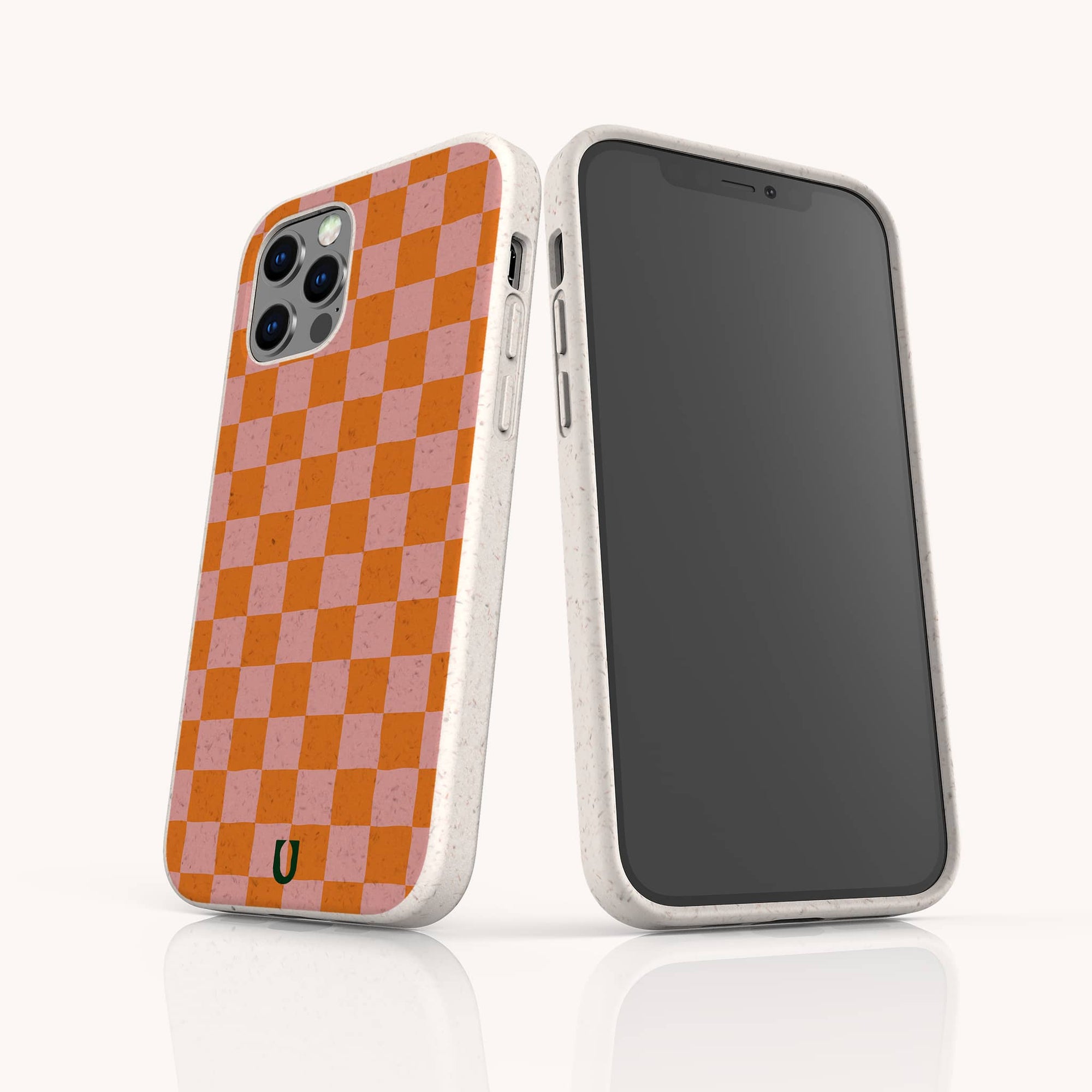 Two smartphones in white-speckled, eco-friendly cases; one shows the front, while the other displays the Orange Checker Eco-Friendly Phone Case’s vibrant orange and pink checkerboard pattern with a small horseshoe-shaped logo at the bottom.