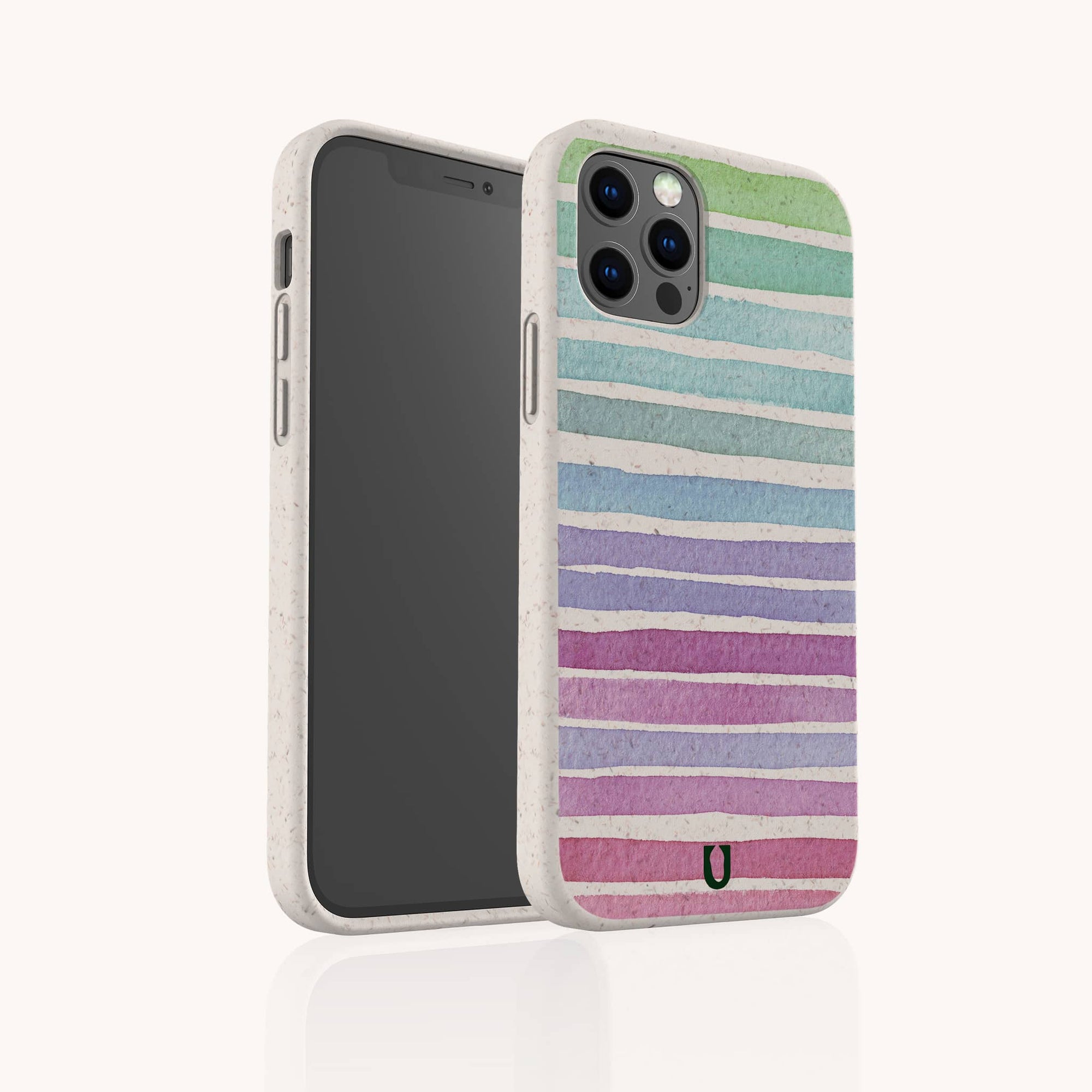 The Winter Rainbow Eco-Friendly Phone Case is shown in speckled white with horizontal pastel stripes in blue, green, purple, and pink—biodegradable and partially turned to display its sustainable style from both the front and back.