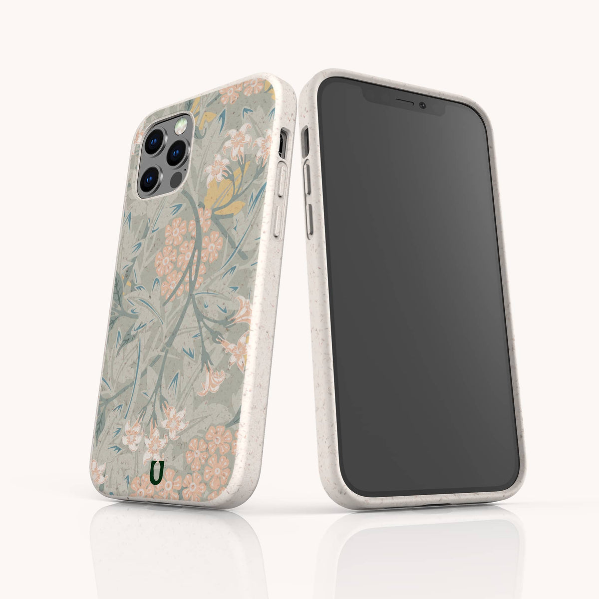 Two smartphones with beige cases are standing upright against a light background; one features the Jasmine Eco-Friendly Phone Case adorned in beautiful green, pink, and yellow floral tones, while the other displays a black screen.