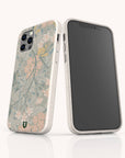 Two smartphones with beige cases are standing upright against a light background; one features the Jasmine Eco-Friendly Phone Case adorned in beautiful green, pink, and yellow floral tones, while the other displays a black screen.