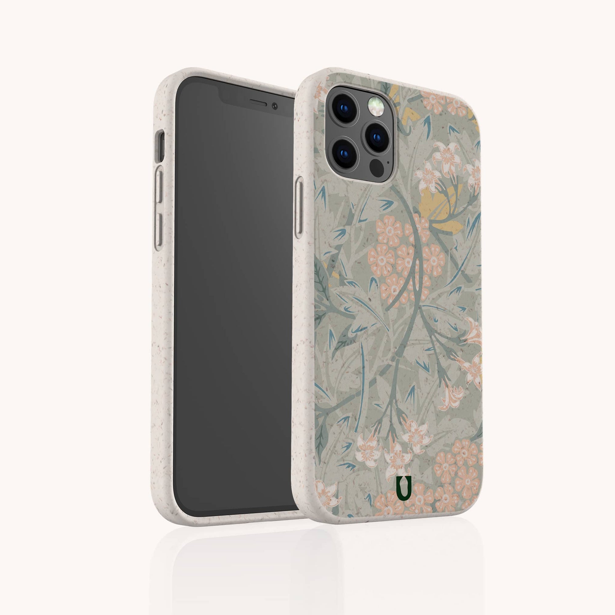 The Jasmine Eco-Friendly Phone Case features a soft, light beige border and botanical floral motifs in muted green, pink, and yellow. The phone case stands upright to show both front and back sides of its sustainable design.