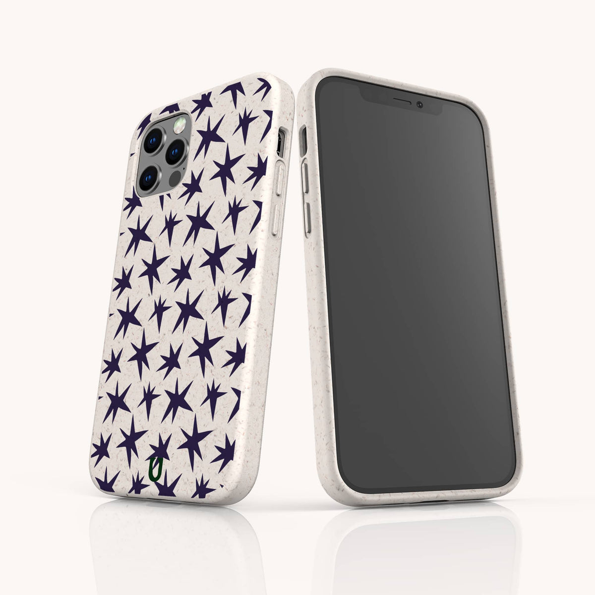 Two smartphones with white Wonky Stars Biodegradable Phone Cases featuring a pattern of dark blue stars. One phone displays the back design, while the other shows the front screen. Both are standing on a white surface.