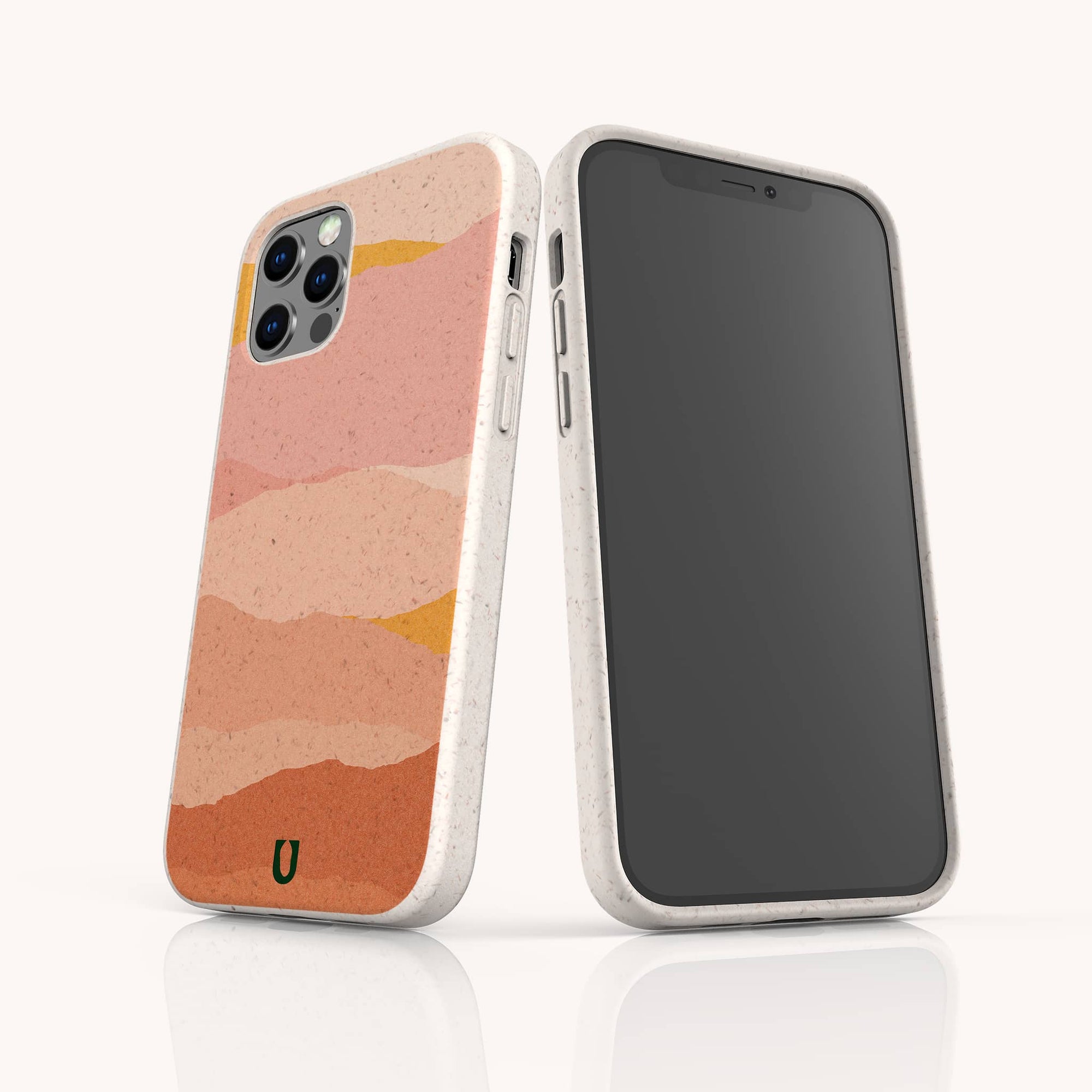 Two smartphones with speckled beige Mountains Eco-Friendly Phone Cases; one displays a screen, the other an abstract pink, peach, and orange layered design with a small green "U." Compatible with iPhone and Samsung Galaxy for sustainable style.