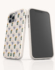 Two smartphone cases stand upright; one shows a blank screen, while the other displays the Sunny Side Up Eco-Friendly Phone Case in cream, decorated with small illustrated cacti and plants in green, yellow, and lavender.