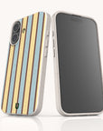 Two Butter and Sky Stripe Eco-Friendly Biodegradable Phone Cases with speckled, off-white frames; one shows a blue and yellow vertical striped pattern, and the other shows a blank dark screen.