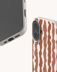 Front and back views of a Cocoa Wave Stripe Eco-Friendly Biodegradable Phone Case with a speckled finish and a vertical wavy brown and white striped pattern.