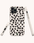 Close-up of Little Black Flowers eco-friendly phone case on iPhone 15 showing minimalist black flower design and smooth matte texture.