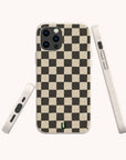 The Black Checker Eco-Friendly Phone Case showcases a chic black and beige checkerboard pattern and is displayed from three perspectives: back, side, and bottom. Highlighting its sustainable design, this eco-friendly case features a subtle green logo near the bottom center.