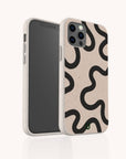 The Black Swirl Lines Eco-Friendly Phone Case features a bold black swirl pattern on a beige background. The phone is shown positioned at an angle that showcases both the screen and the artistic back design, all set against a simple light backdrop.