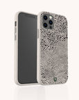 Introducing the Mini Strokes Eco-Friendly Biodegradable Phone Case, a sustainable phone accessory with a textured design of black dots and wavy lines on an off-white background, displayed from both front and back views.