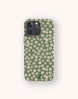 The Vintage Green Flowers Eco-Friendly Phone Case, featuring a green background adorned with a vintage pattern of small white and pink flowers, is displayed against a light beige backdrop.