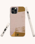 The Caramel Abstract Strokes Eco-Friendly Phone Case is shown in beige with abstract pink, tan, and gold shapes, plus a small green logo at the bottom. Displayed from the back, side, and bottom angles, this case offers sustainable protection and is compatible with both iPhone and Samsung models—seamlessly blending style with environmental responsibility.