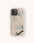 The Green Abstract Lines Eco-Friendly Phone Case, in beige and adorned with green, black, and gray abstract lines and shapes, is displayed on a light background.