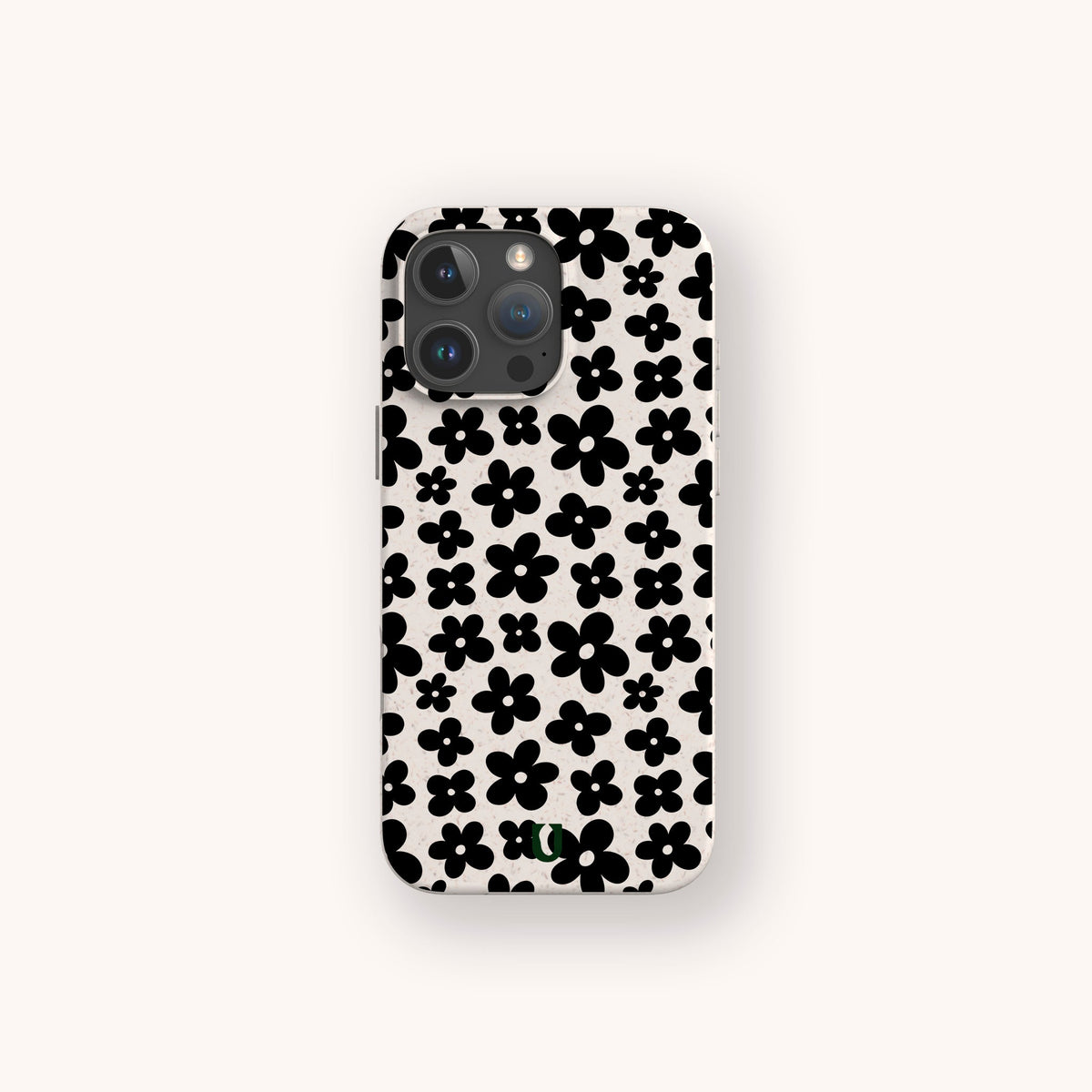A smartphone with a Black Flower Power Eco-Friendly Phone Case, which features a pattern of black flowers on a white background, displayed against a plain light-colored backdrop.