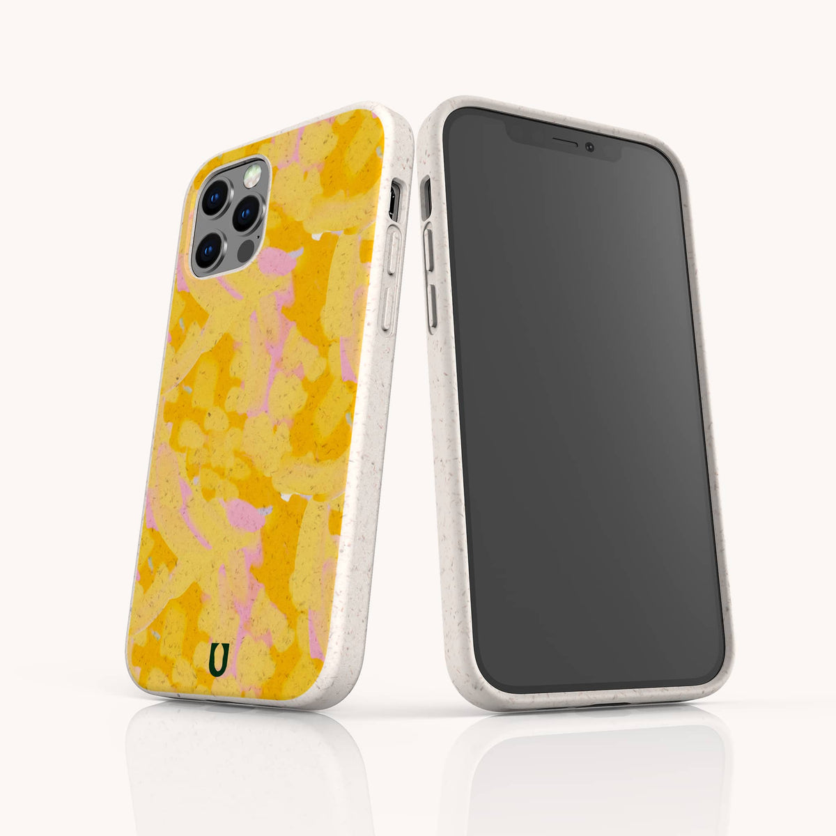Two smartphones in white speckled Papaya Eco-Friendly Biodegradable Phone Cases; one reveals a yellow and pink abstract pattern on the back, while the other displays its front touchscreen. Both are positioned upright on a white reflective surface.
