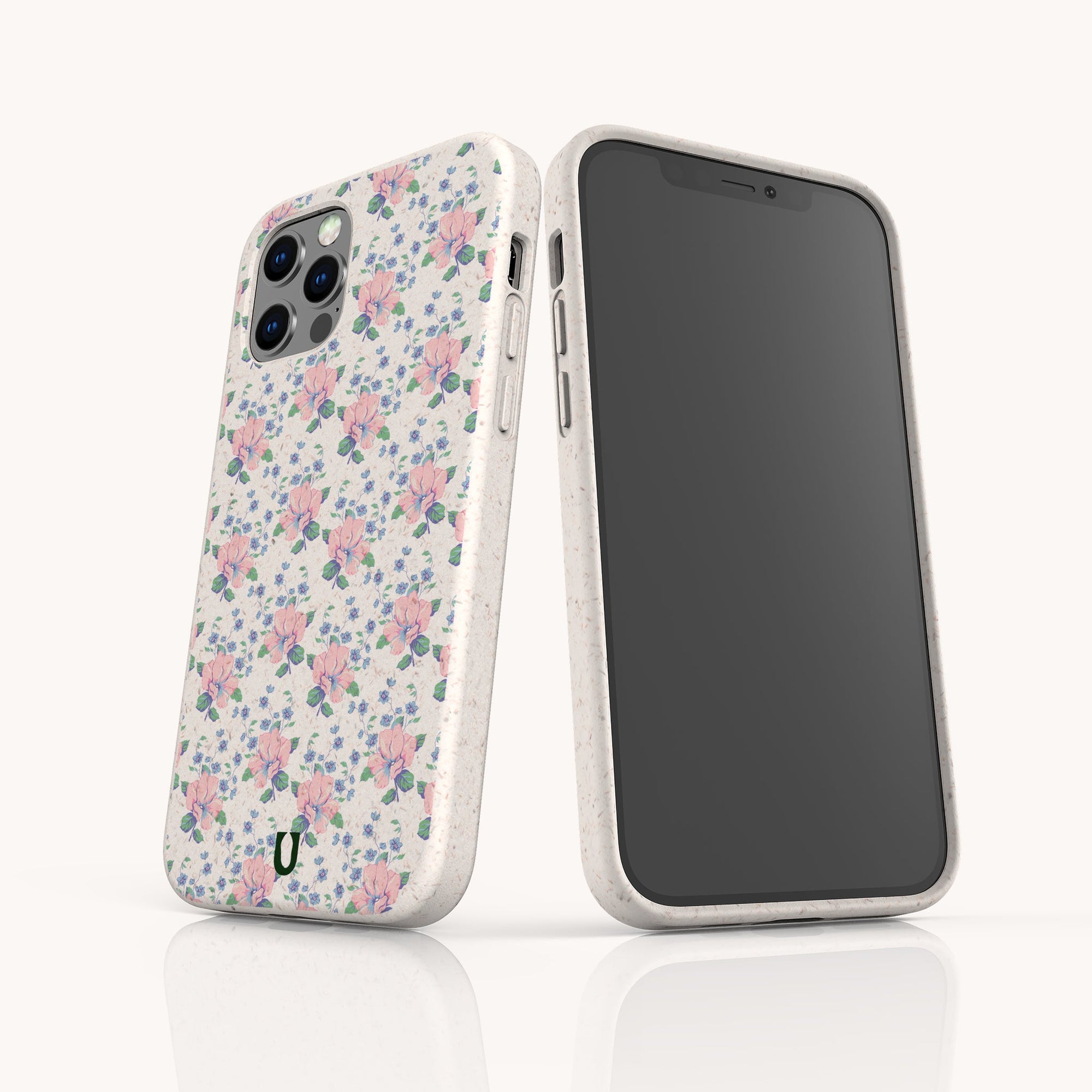 Two smartphones in Pink Coquette Flowers Eco-Friendly Biodegradable Phone Cases—one displays the pastel floral design, the other a plain black screen. Both stand upright on a reflective surface, showcasing sustainable craftsmanship.