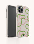 Two smartphones in beige, speckle-textured Green and Pink Swirl Lines Eco-Friendly Phone Cases—each case features abstract pink and green wavy lines. One phone displays the artistic back of the case, while the other shows its front screen. These eco-friendly cases fit both iPhone and Samsung Galaxy models.