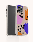 The Memphis Eco-Friendly Biodegradable Phone Case features an abstract design with orange, purple, and pink paint-like shapes accented by black dots on a beige background. Inspired by classic Memphis style, this case offers comprehensive coverage for your large-screen black phone while highlighting both its unique pattern and eco-conscious materials.