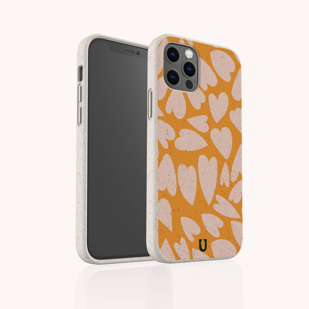 The Orange Hearts Eco-Friendly Biodegradable Phone Case is showcased on a smartphone, displaying its vibrant orange color and pink heart pattern. The phone is pictured from both the front and back, emphasizing the camera area and the case’s textured, sustainable edges.