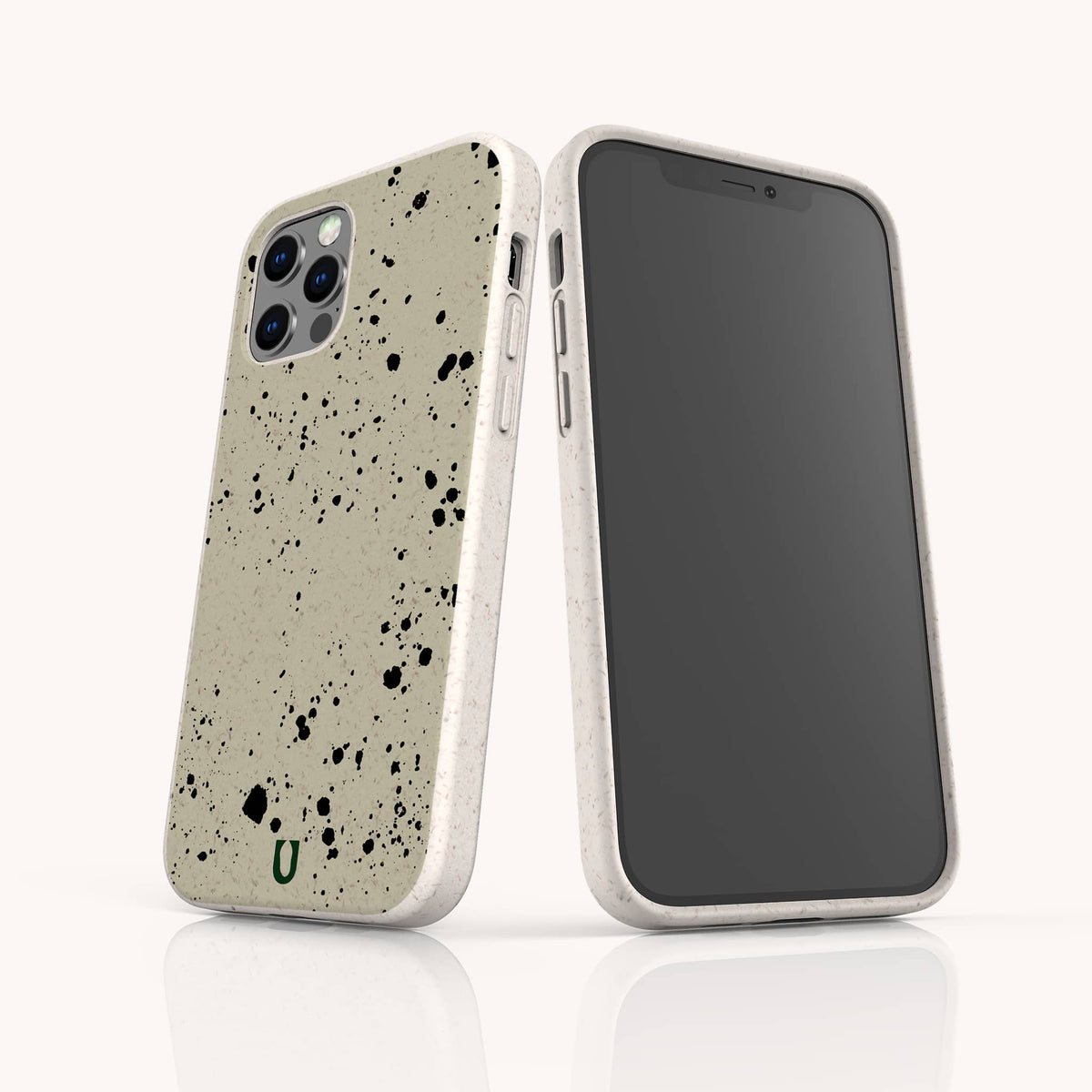 Two smartphones in beige Grunge Eco-Friendly Phone Cases with black paint splatters stand upright—one displaying the back and the other showcasing the front screen—against a white background.