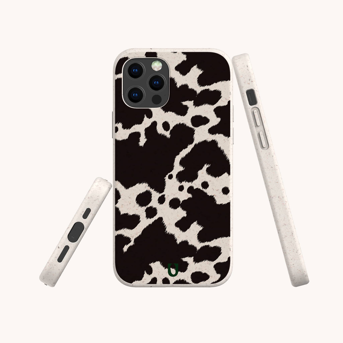 The Cow Print Eco-Friendly Phone Case is shown on a smartphone in a stylish black and white cow print design, captured from the back and sides against a plain light background. This case is compatible with both iPhone and Samsung devices.