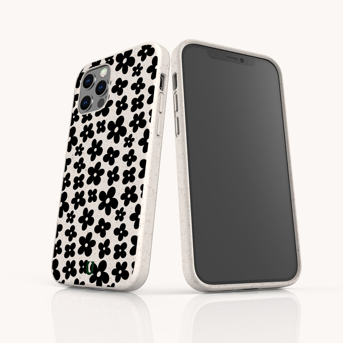 Two smartphones with matching Black Flower Power Eco-Friendly Phone Cases featuring a black floral pattern; one phone displays the retro floral case design on the back, while the other shows its blank black screen facing forward.