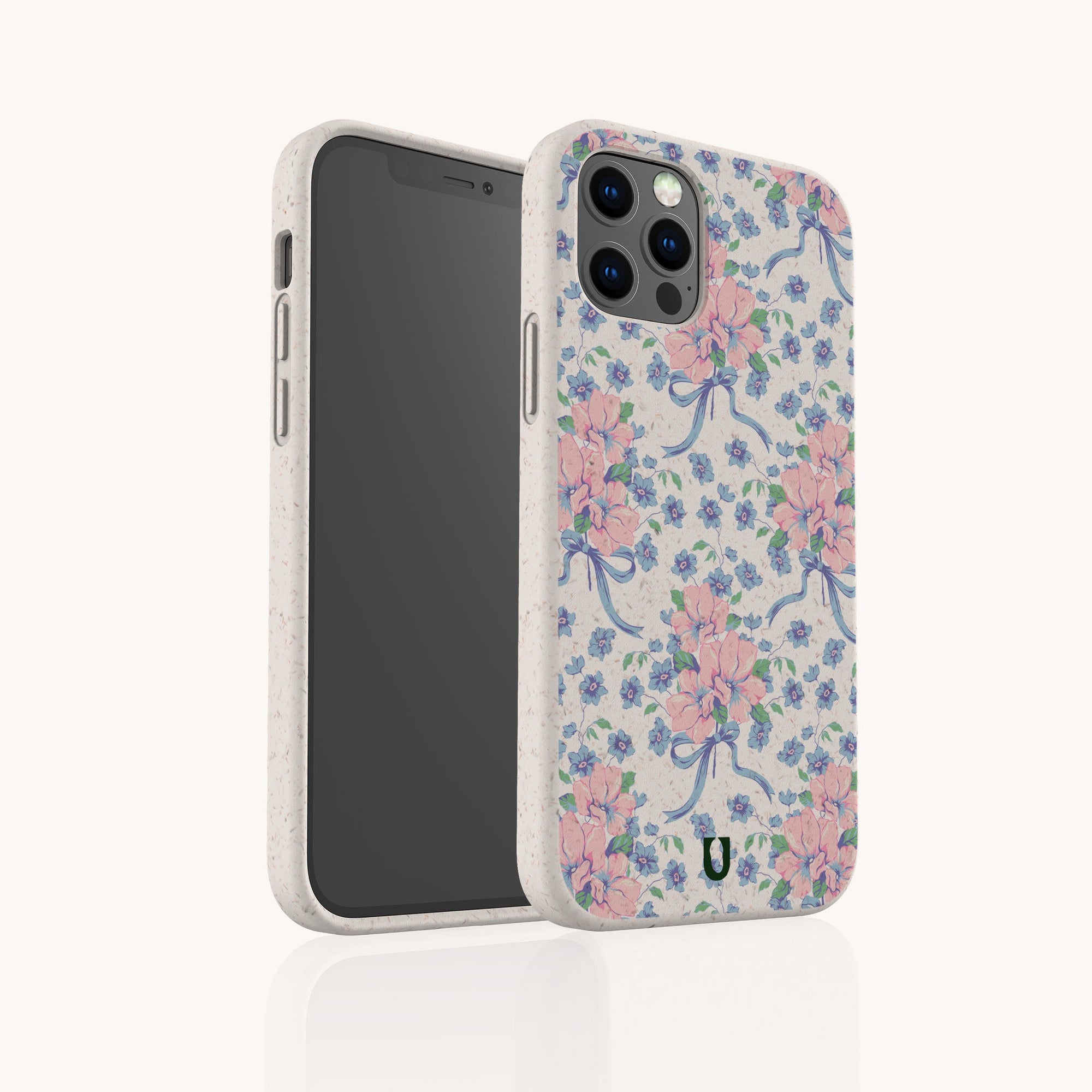 The Pink and Blue Coquette Flowers Eco-Friendly Biodegradable Phone Case features pastel floral patterns with pink and blue coquette flowers and blue ribbons on a light background, shown with a phone partially inside to display its design.