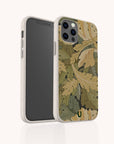 A smartphone with a camera and black screen is displayed in the Flower Garden Eco-Friendly Phone Case, which features a pattern of overlapping green and brown leaves and includes a small green emblem at the bottom.