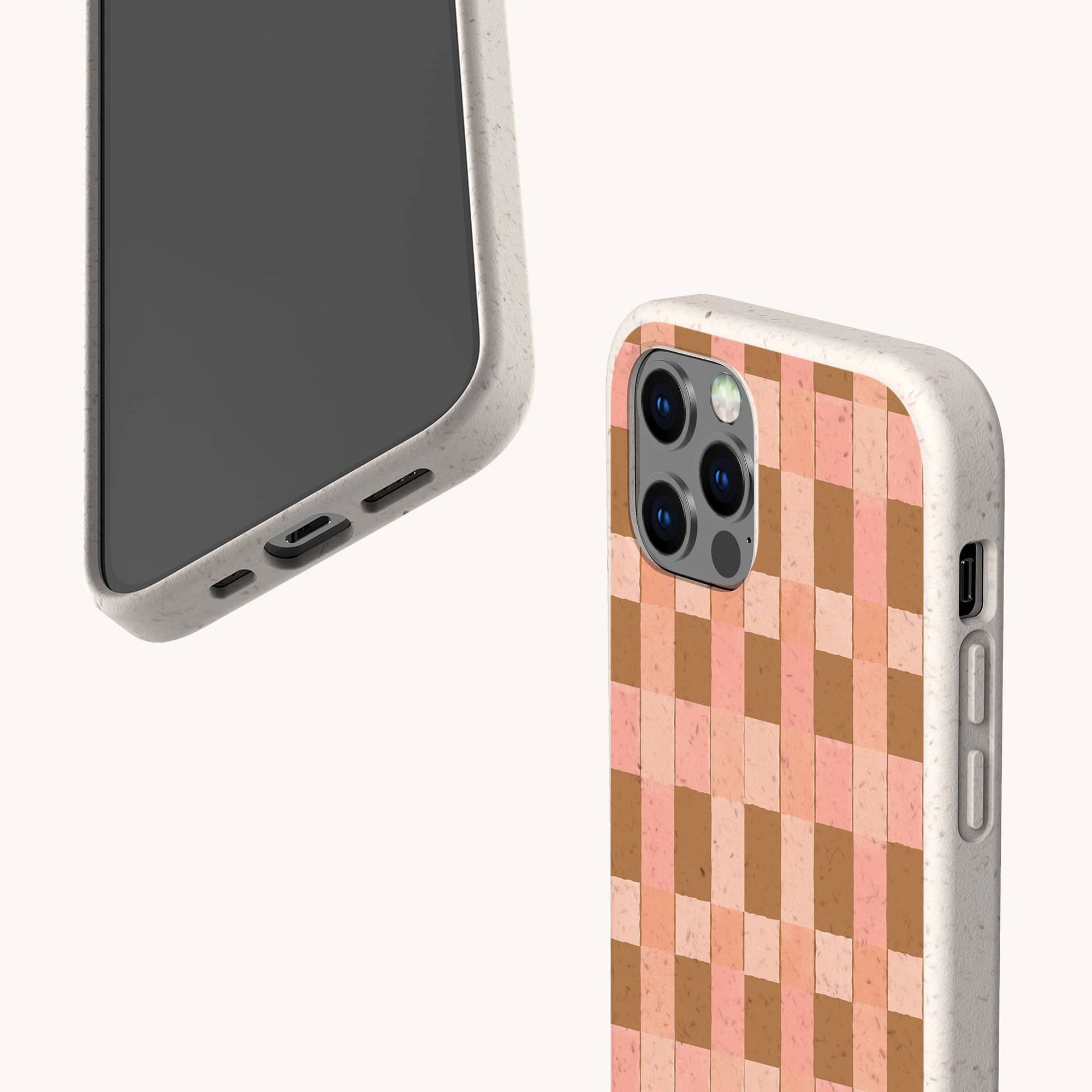Two smartphones feature the Pink and Brown Watercolour Checker Eco-Friendly Phone Case—one shows the front screen, while the other displays its compostable beige speckled back with a unique pink and brown checkerboard pattern.