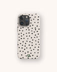 The Black Hearts Eco-Friendly Phone Case is a beige smartphone cover adorned with small, scattered black hearts, photographed against a simple light background.